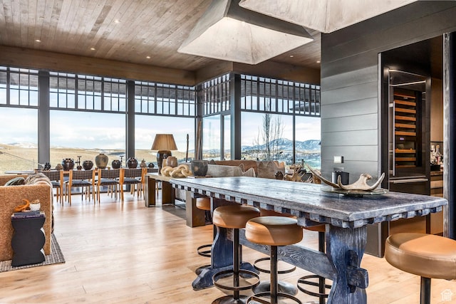 8006 N Sunrise Loop, Park City, UT 84098 - dining space with wood walls, expansive windows, wooden ceiling, a mountain view, and wood finished floors