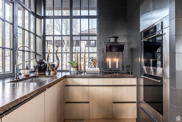 8006 N Sunrise Loop, Park City, UT 84098 - kitchen with double oven, dark countertops, and a sink
