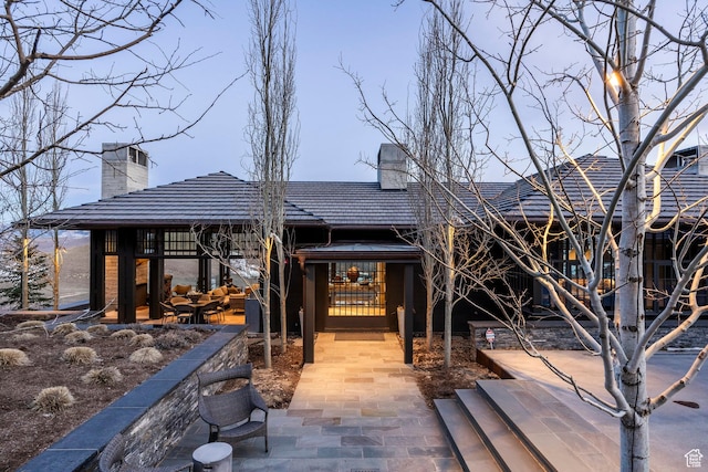 8006 N Sunrise Loop, Park City, UT 84098 - rear view of property with a chimney and a patio area