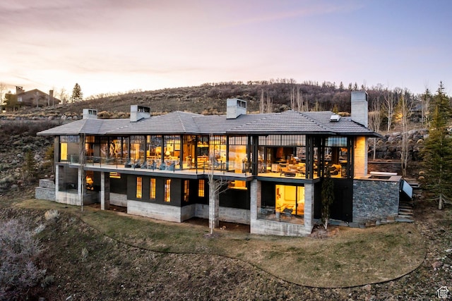 8006 N Sunrise Loop, Park City, UT 84098 - back of property at dusk featuring a chimney