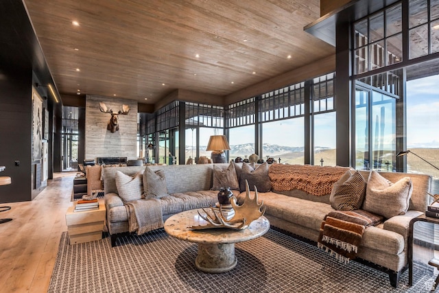 8006 N Sunrise Loop, Park City, UT 84098 - living room with wooden ceiling, a stone fireplace, recessed lighting, a mountain view, and hardwood / wood-style floors