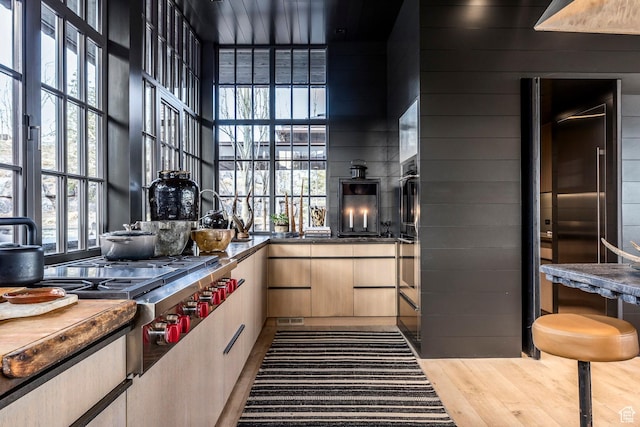 8006 N Sunrise Loop, Park City, UT 84098 - kitchen featuring a high ceiling, wood finished floors, wooden walls, and plenty of natural light