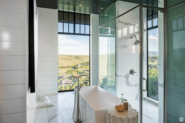 8006 N Sunrise Loop, Park City, UT 84098 - bathroom with marble tiled floors, healthy amount of natural light, and a soaking tub
