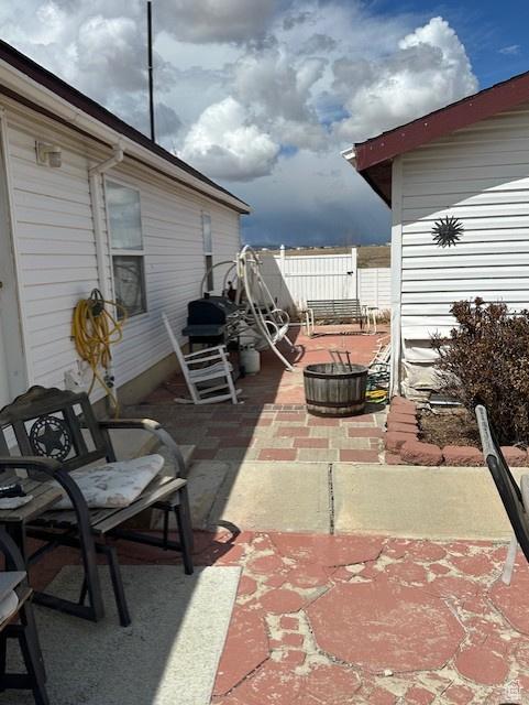 view of patio featuring fence