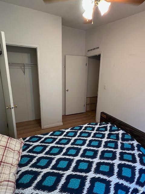 1557 E 8900 S, Price, UT 84501 - bedroom featuring wood finished floors, a closet, and baseboards