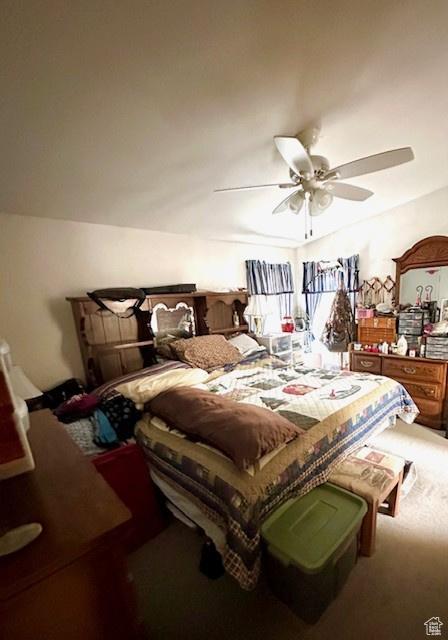 carpeted bedroom featuring ceiling fan
