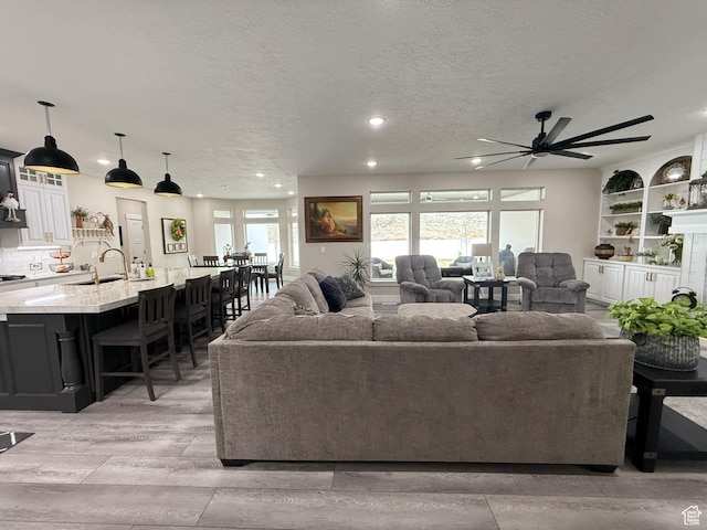 1240 W 2360 N, Helper, UT 84526 - living room featuring a textured ceiling, ceiling fan, light wood-style flooring, and recessed lighting