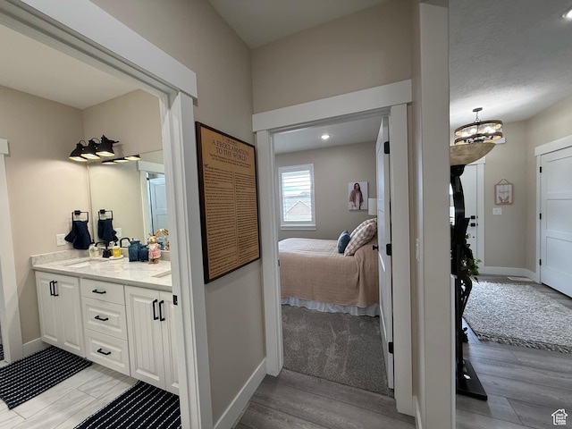 1240 W 2360 N, Helper, UT 84526 - bathroom with vanity, baseboards, a chandelier, and wood finished floors