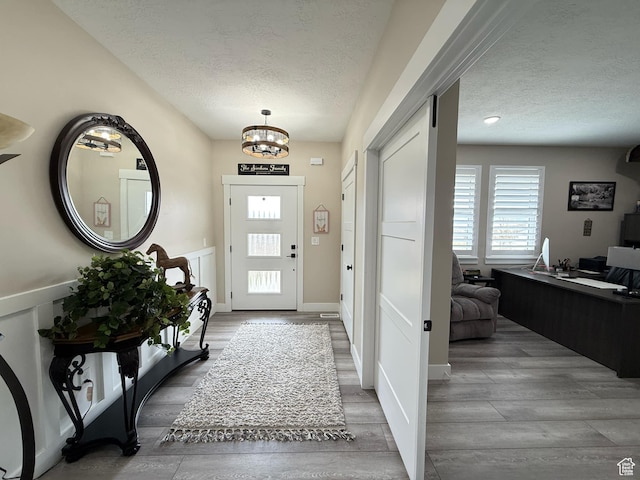 1240 W 2360 N, Helper, UT 84526 - foyer with a textured ceiling, wood finished floors, and a chandelier
