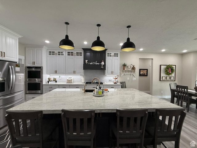 1240 W 2360 N, Helper, UT 84526 - kitchen featuring tasteful backsplash, light wood-style flooring, recessed lighting, and stainless steel appliances