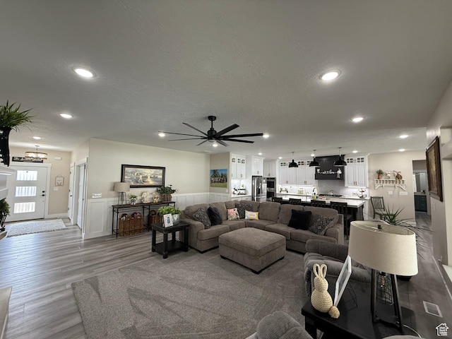 1240 W 2360 N, Helper, UT 84526 - living area with a wainscoted wall, wood finished floors, a textured ceiling, ceiling fan with notable chandelier, and recessed lighting