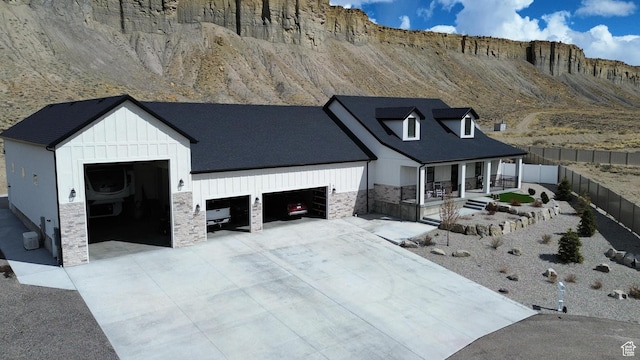 1240 W 2360 N, Helper, UT 84526 - modern farmhouse featuring driveway, stone siding, an attached garage, fence, and board and batten siding