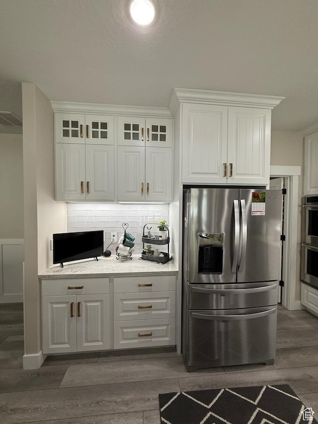 1240 W 2360 N, Helper, UT 84526 - kitchen featuring white cabinets, wood finished floors, decorative backsplash, and stainless steel appliances