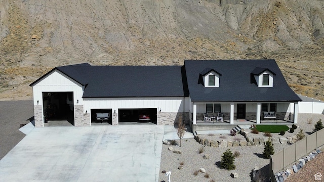 1240 W 2360 N, Helper, UT 84526 - view of front of property with stone siding, concrete driveway, fence, and an attached garage