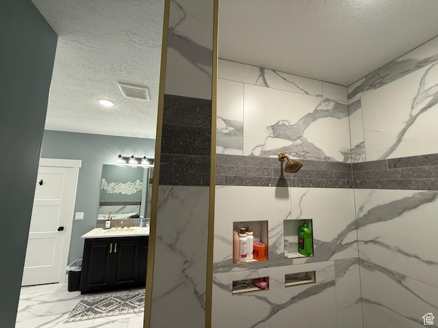 1240 W 2360 N, Helper, UT 84526 - full bath with vanity, a marble finish shower, a textured ceiling, marble finish floor, and visible vents