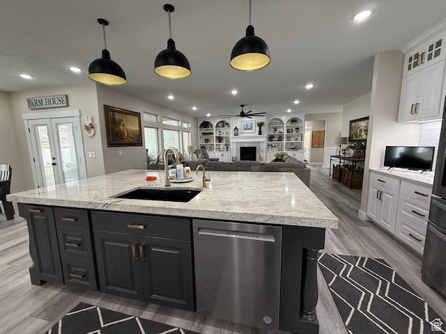 1240 W 2360 N, Helper, UT 84526 - kitchen featuring an island with sink, white cabinetry, a sink, and stainless steel dishwasher