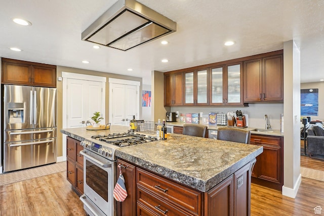 1349 E Madera Hills Dr S, Bountiful, UT 84010 - kitchen with light wood-style flooring, appliances with stainless steel finishes, a sink, and glass insert cabinets