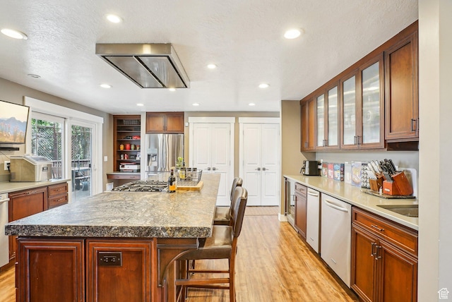 1349 E Madera Hills Dr S, Bountiful, UT 84010 - kitchen featuring glass insert cabinets, light wood-style flooring, appliances with stainless steel finishes, and a kitchen breakfast bar