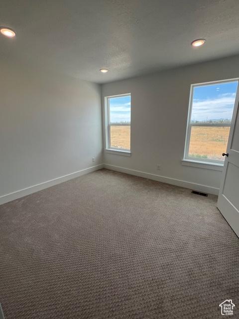 3199 N 3500 W Unit 379, Plain City, UT 84404 - empty room with light colored carpet and recessed lighting