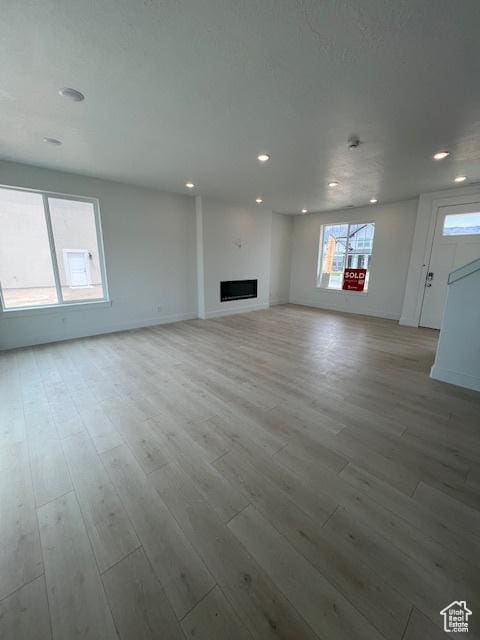 3199 N 3500 W Unit 379, Plain City, UT 84404 - unfurnished living room with recessed lighting, wood finished floors, and a fireplace