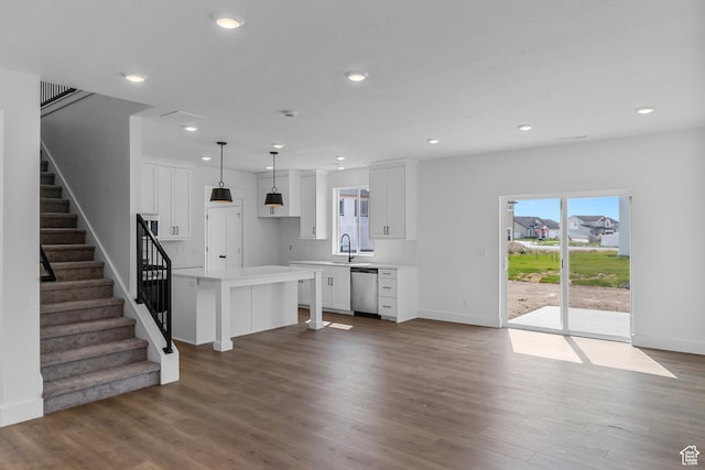 3199 N 3500 W Unit 379, Plain City, UT 84404 - kitchen featuring white cabinetry, light countertops, decorative backsplash, stainless steel dishwasher, and wood finished floors