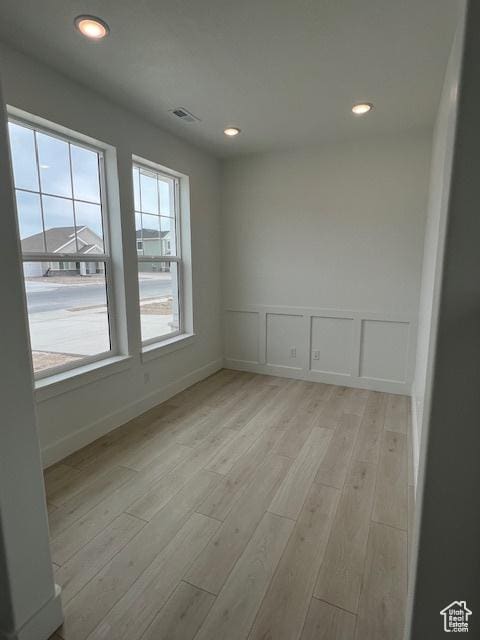 3199 N 3500 W Unit 379, Plain City, UT 84404 - unfurnished room featuring light wood-style floors, recessed lighting, a decorative wall, and wainscoting