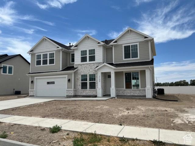 3199 N 3500 W Unit 379, Plain City, UT 84404 - craftsman-style home featuring stone siding, a garage, concrete driveway, and a porch