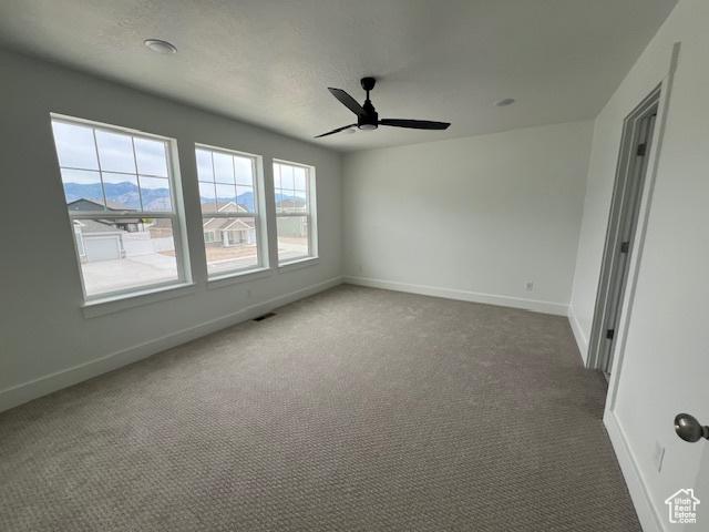 3199 N 3500 W Unit 379, Plain City, UT 84404 - spare room with carpet floors and a ceiling fan
