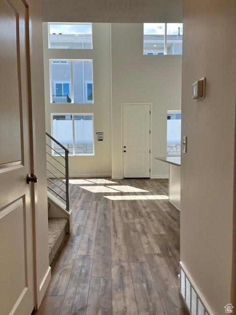 6850 S Static Peak Dr Unit 261, West Jordan, UT 84081 - foyer entrance with baseboards, hardwood / wood-style floors, a high ceiling, and stairway