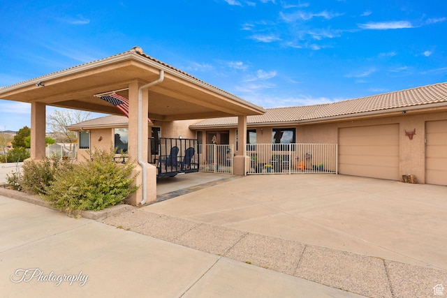 exterior space featuring driveway, stucco siding, fence, and an attached garage