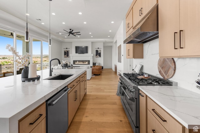 1248 S Seminole Way, Washington, UT 84780 - kitchen with stainless steel dishwasher, range with gas stovetop, a sink, under cabinet range hood, and a ceiling fan