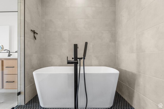 1248 S Seminole Way, Washington, UT 84780 - full bathroom featuring tile walls, tile patterned floors, a freestanding tub, and vanity