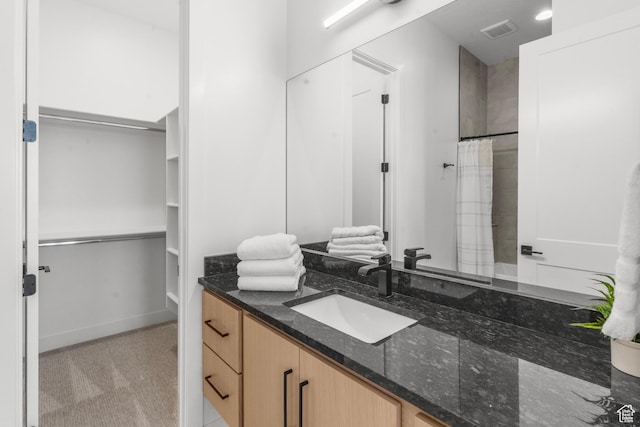 1248 S Seminole Way, Washington, UT 84780 - full bathroom with vanity, a walk in closet, and a shower with shower curtain