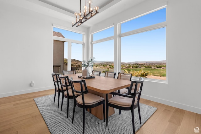 1248 S Seminole Way, Washington, UT 84780 - dining area featuring baseboards, a chandelier, light wood finished floors, a raised ceiling, and a mountain view
