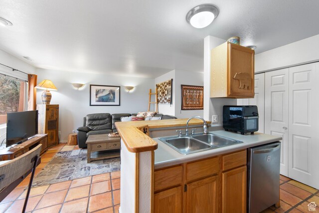 3245 E Fairway Loop, Moab, UT 84532 - kitchen featuring stainless steel dishwasher, light tile patterned floors, a sink, light countertops, and open floor plan