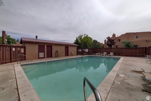 3245 E Fairway Loop, Moab, UT 84532 - community pool featuring a patio area and fence