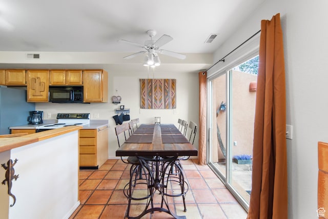 3245 E Fairway Loop, Moab, UT 84532 - kitchen featuring visible vents, black microwave, light countertops, and range with electric stovetop