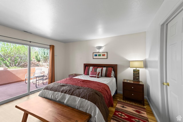 3245 E Fairway Loop, Moab, UT 84532 - bedroom featuring light wood-style flooring and access to exterior