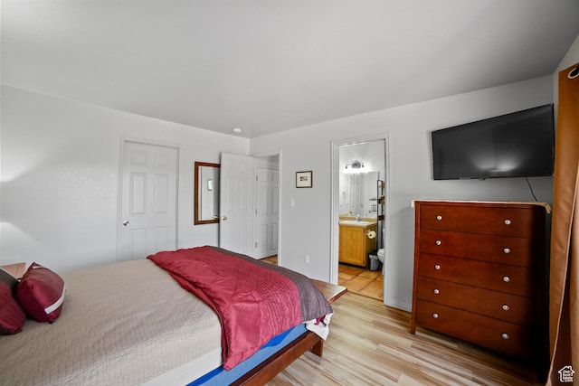3245 E Fairway Loop, Moab, UT 84532 - bedroom featuring a sink, light wood-type flooring, and ensuite bath