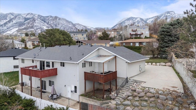 6958 S Sunrise Hills Cir E, Cottonwood Heights, UT 84121 - rear view of property featuring central AC, a mountain view, fence, and a patio area
