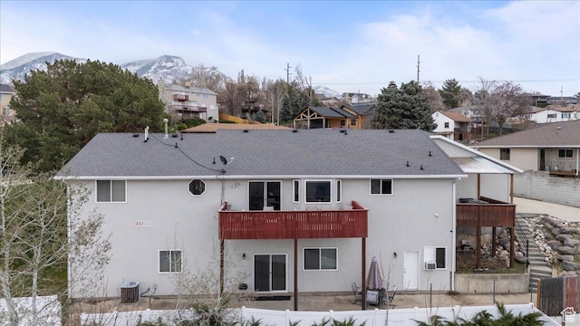 6958 S Sunrise Hills Cir E, Cottonwood Heights, UT 84121 - rear view of property with fence, a shingled roof, and stucco siding