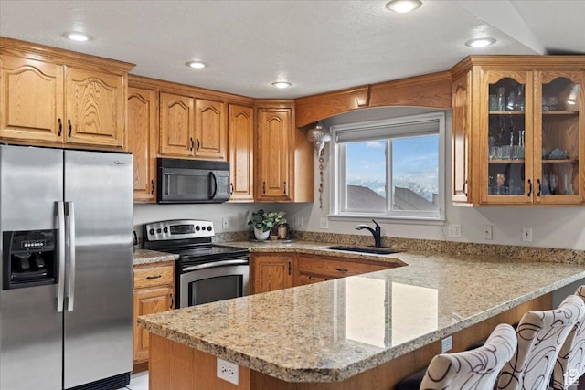 6958 S Sunrise Hills Cir E, Cottonwood Heights, UT 84121 - kitchen featuring a sink, stainless steel appliances, glass insert cabinets, a breakfast bar area, and a peninsula