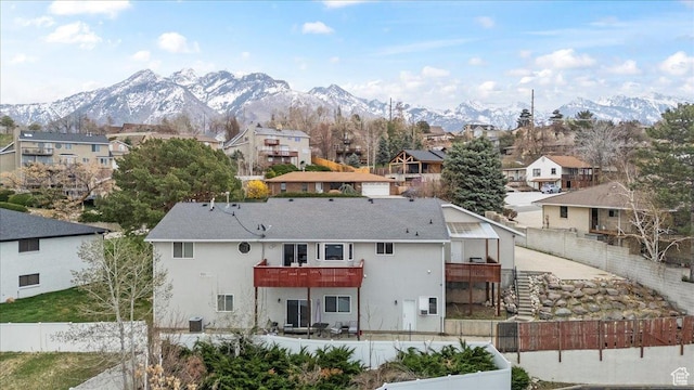 6958 S Sunrise Hills Cir E, Cottonwood Heights, UT 84121 - rear view of property with a residential view, a deck with mountain view, and a fenced backyard