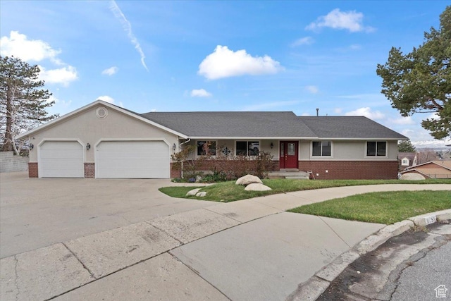 single story home with a garage, stucco siding, roof with shingles, brick siding, and driveway