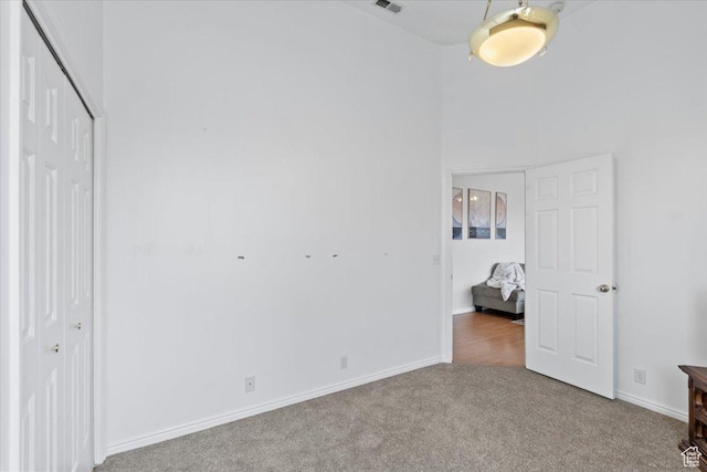 6958 S Sunrise Hills Cir E, Cottonwood Heights, UT 84121 - unfurnished bedroom featuring a closet, baseboards, and carpet floors