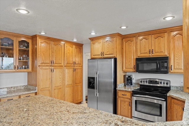 6958 S Sunrise Hills Cir E, Cottonwood Heights, UT 84121 - kitchen featuring glass insert cabinets, appliances with stainless steel finishes, light stone countertops, recessed lighting, and brown cabinetry