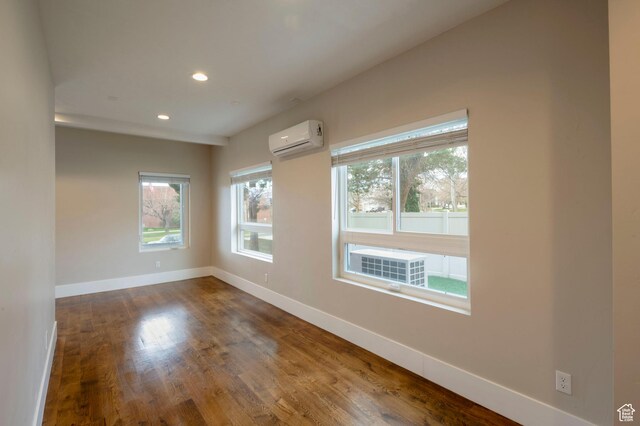 51 S 800 E, Salt Lake City, UT 84102 - unfurnished room with baseboards, a wall mounted AC, dark wood-style flooring, and recessed lighting
