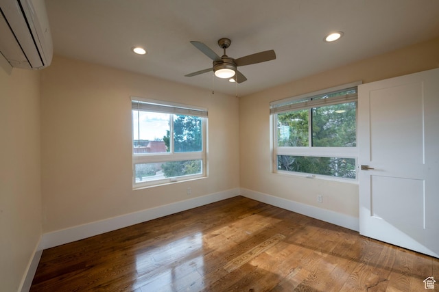51 S 800 E, Salt Lake City, UT 84102 - spare room with recessed lighting, a wall unit AC, baseboards, and wood finished floors