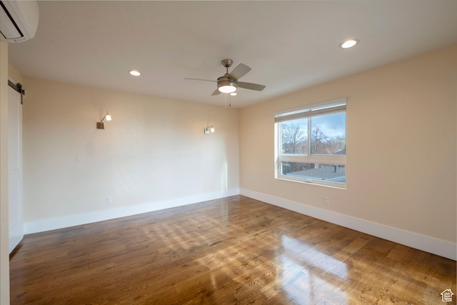 51 S 800 E, Salt Lake City, UT 84102 - spare room featuring a ceiling fan, a barn door, a wall mounted air conditioner, and wood finished floors