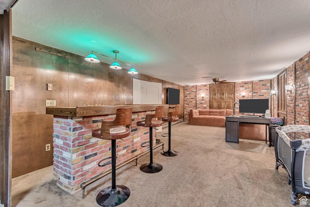 5518 S 875 E, South Ogden, UT 84405 - bar featuring a textured ceiling, wooden walls, carpet floors, and a ceiling fan